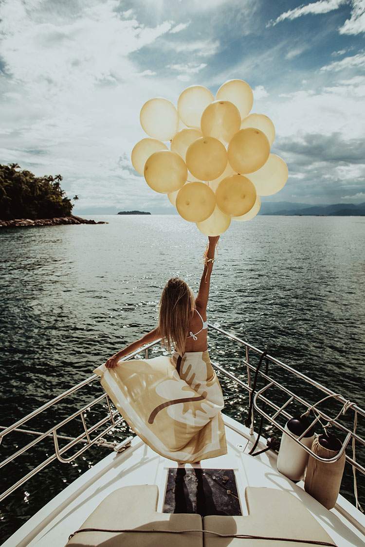 Happy joyous young female wears blue dress, fashionable shoes, chooses  outfit and footwear in one color, going to celebrate birthday, poses  against studio background with inflated air balloons Stock Photo | Adobe