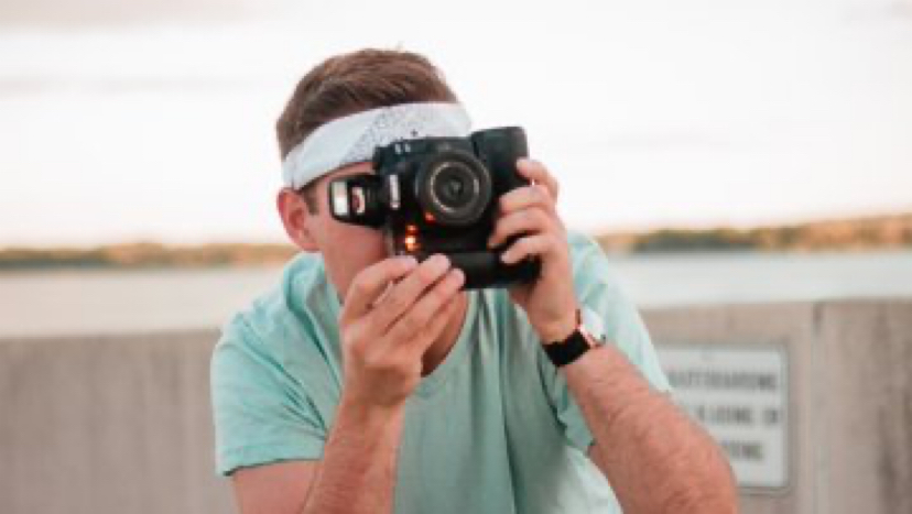 photographer holding camera with pop flash on