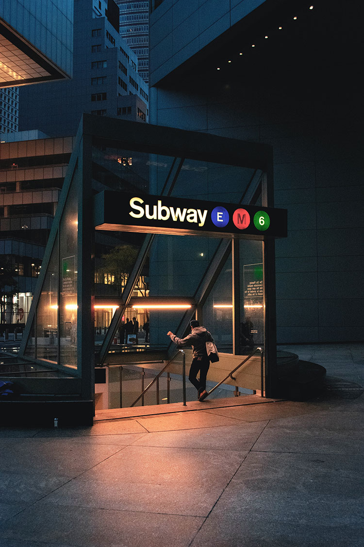Man talking down subway enterance