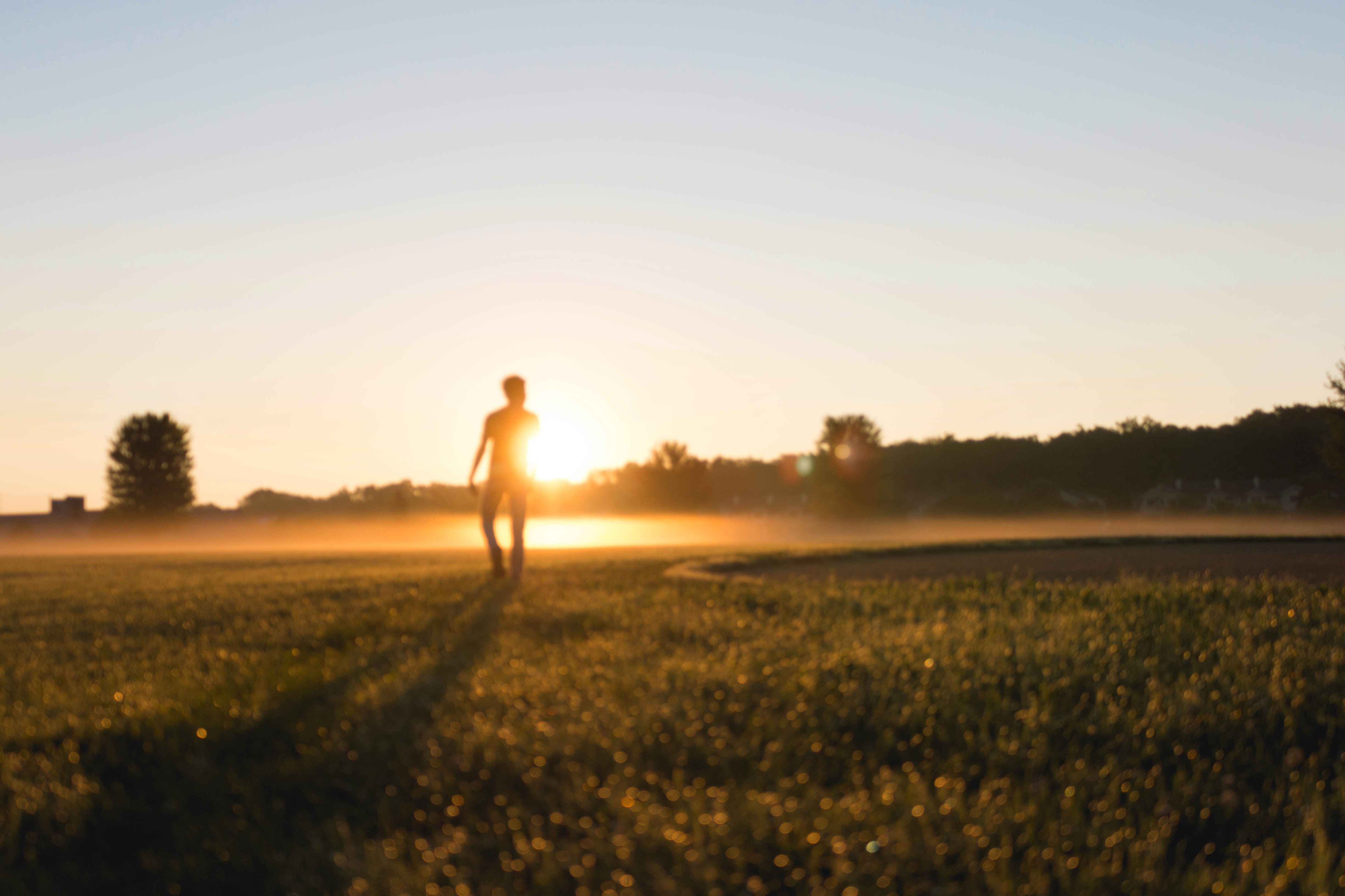 Sunrise Photo of a Person on a Field
